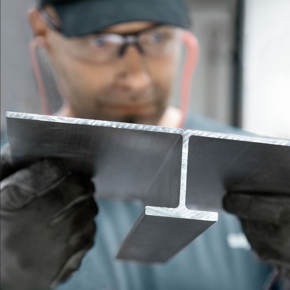 a man wearing a black hat and black gloves holding a black object